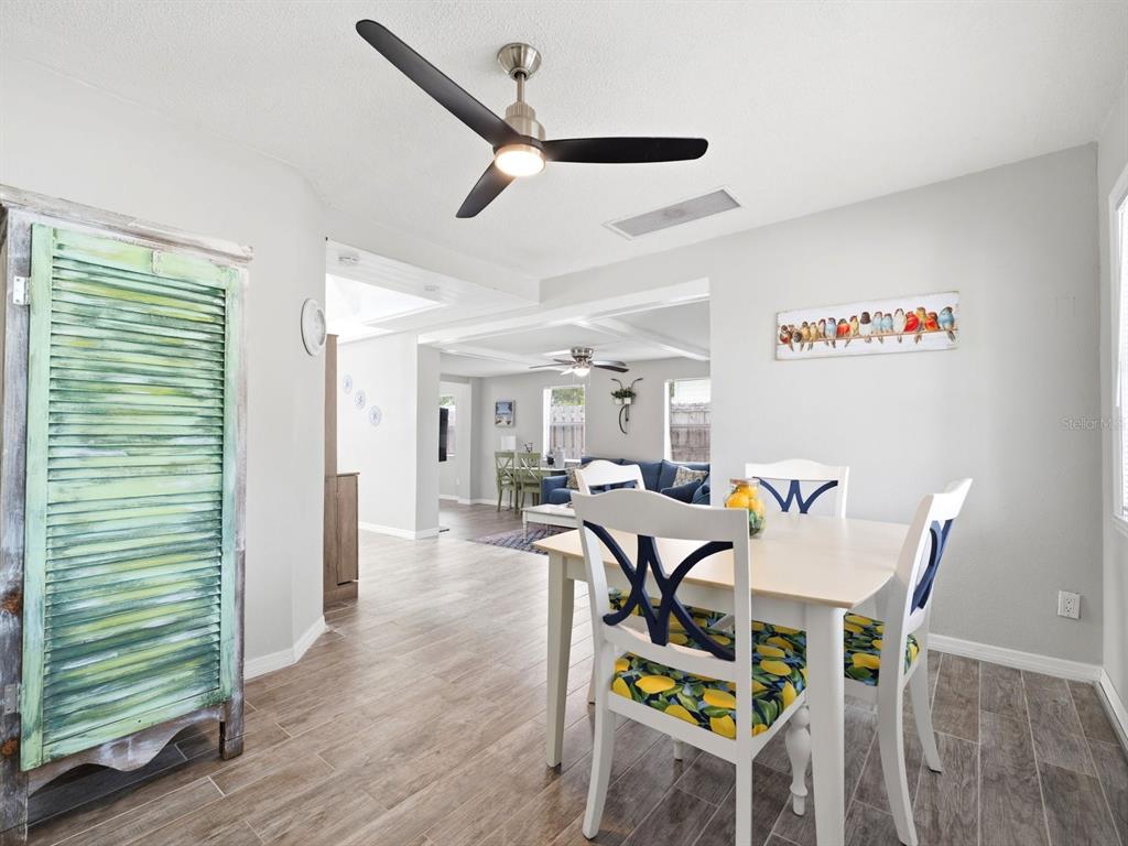 1207 1st Street Indian Rocks Beach, FL 33785 - Photo 6 of 60 a view of a dining room with furniture and a ceiling fan