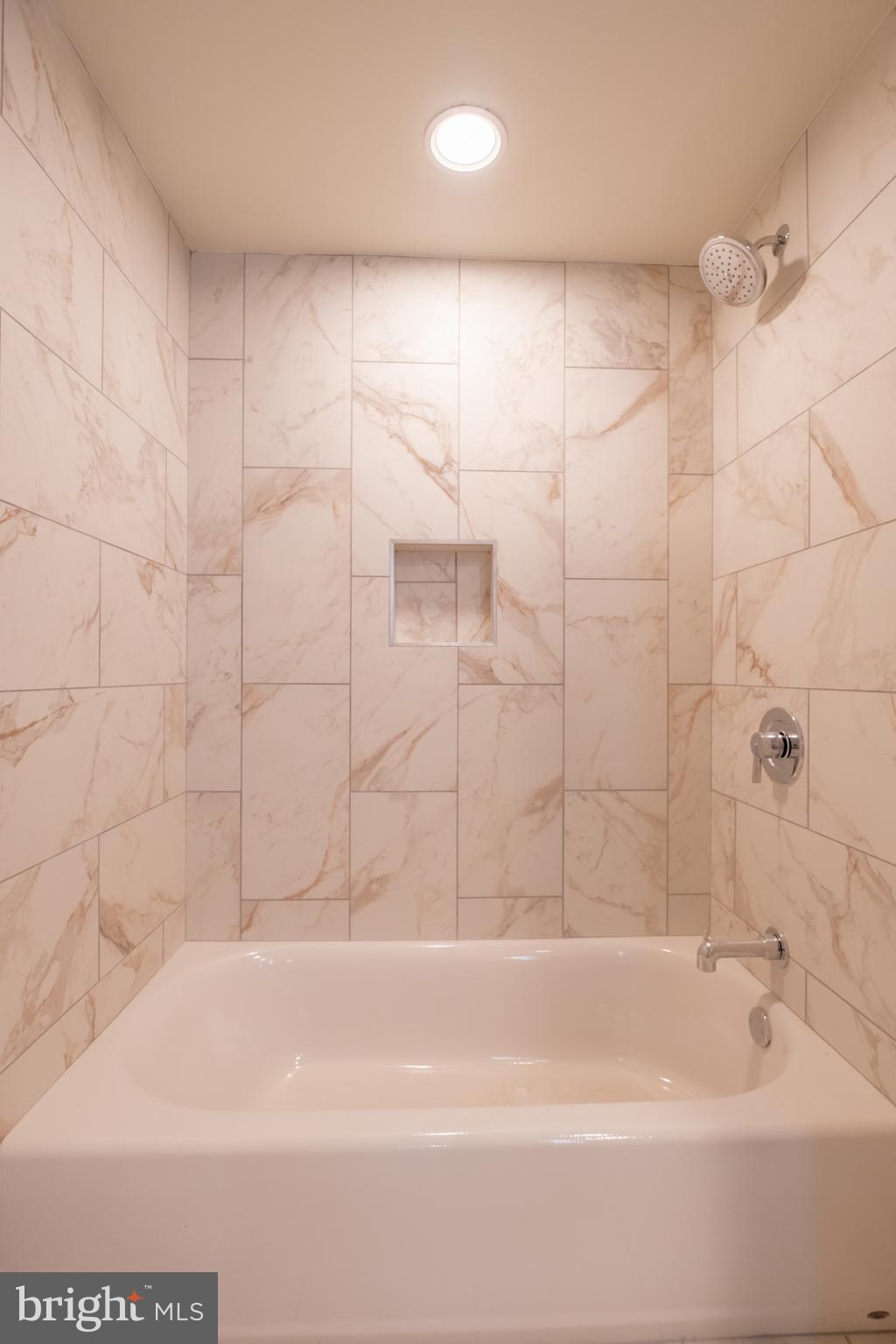 2301-61 John F Kennedy Boulevard, Unit 201 Philadelphia, PA 19103 - Photo 15 of 36 a bathroom with a shower and a bath tub