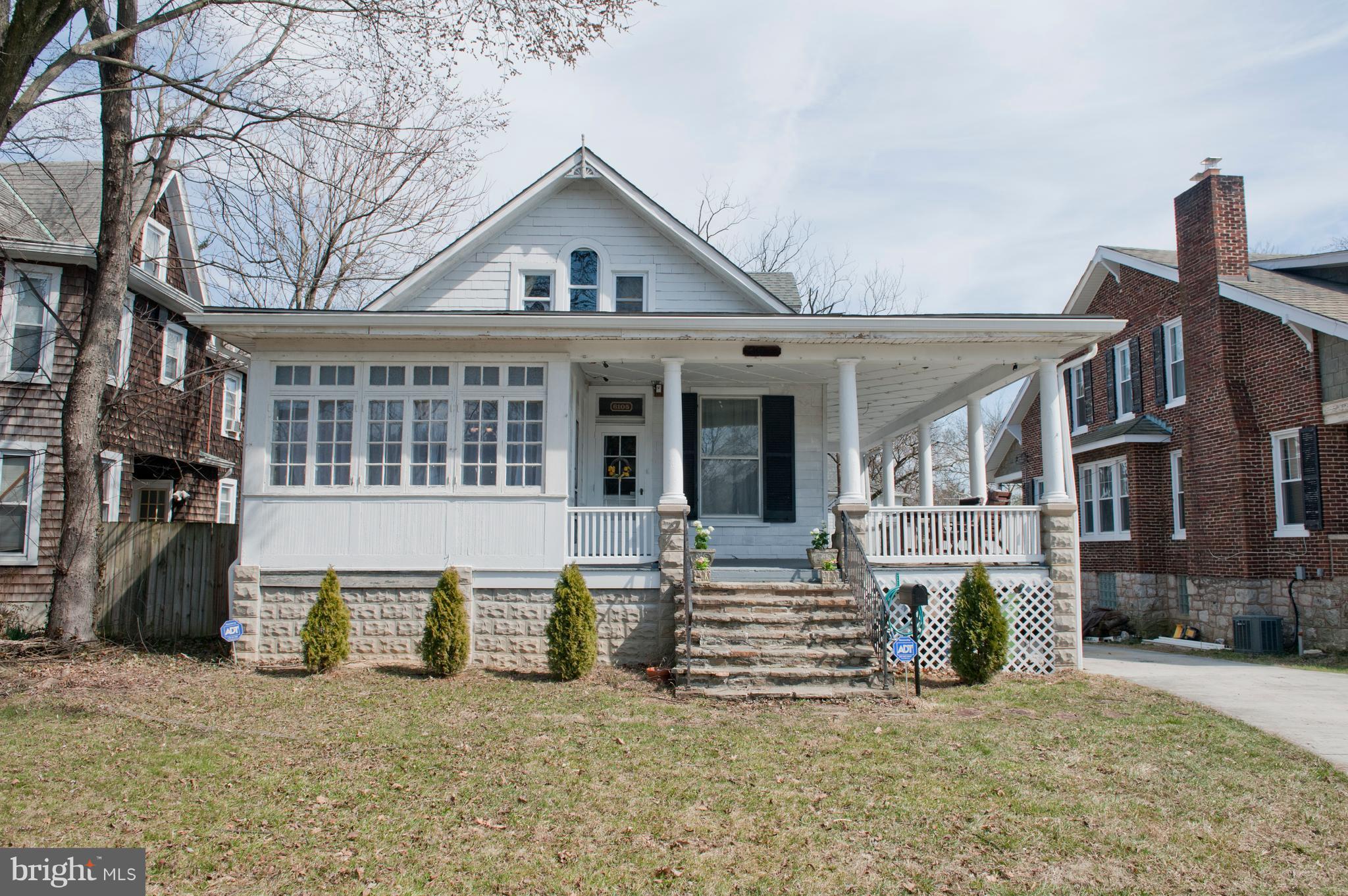 a view of a house with a patio and a yard