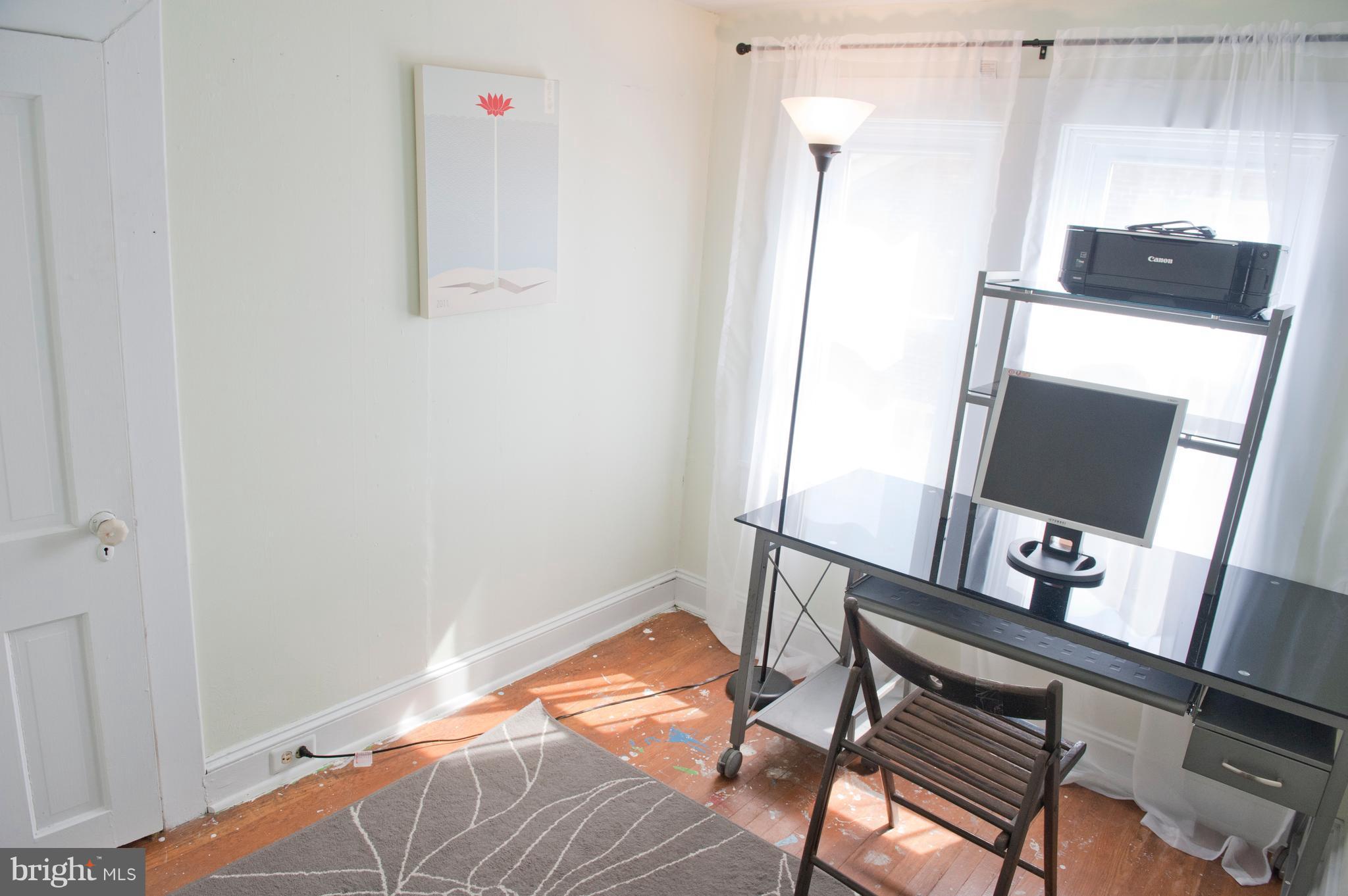6105 York Road Baltimore, MD 21212 - Photo 21 of 24 a bedroom with a bed and a flat tv screen