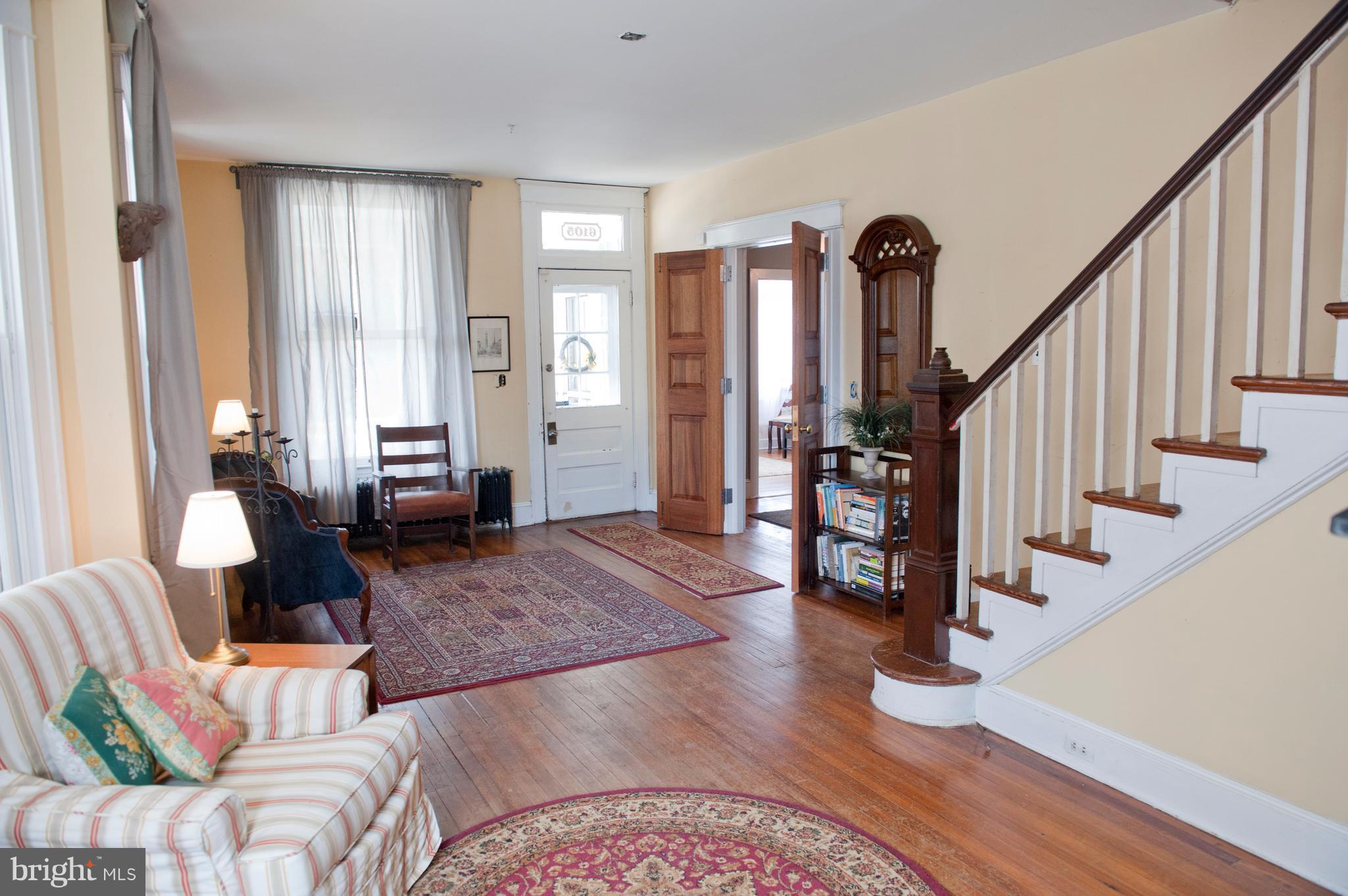 6105 York Road Baltimore, MD 21212 - Photo 6 of 24 a living room with furniture and stairs with wooden floor
