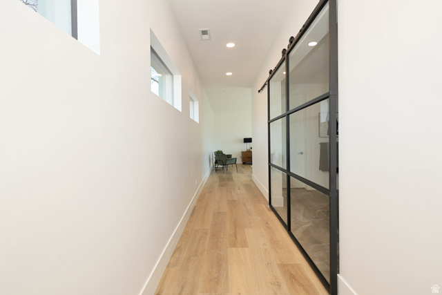 1306 East Victor Lane Draper, UT 84020 - Photo 29 of 60 Corridor with a barn door, light wood-type flooring, and recessed lighting