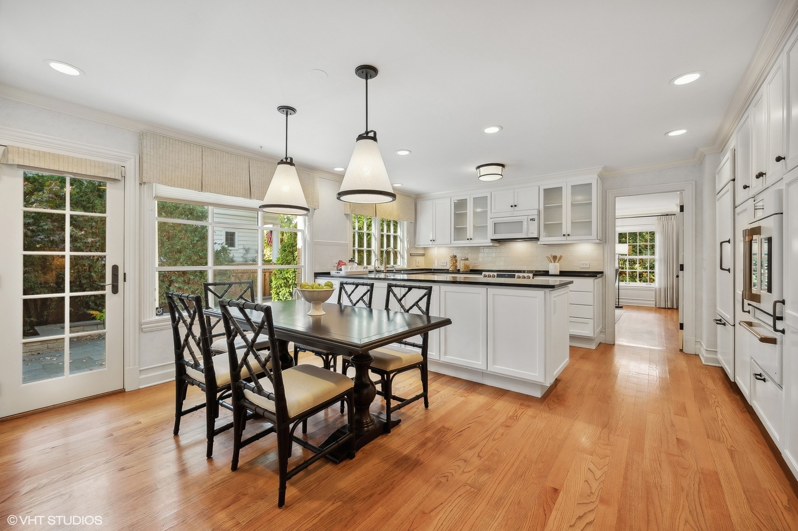 88 Abbotsford Road Winnetka, IL 60093 - Photo 15 of 46 a view of a dining room and livingroom with furniture wooden floor a chandelier