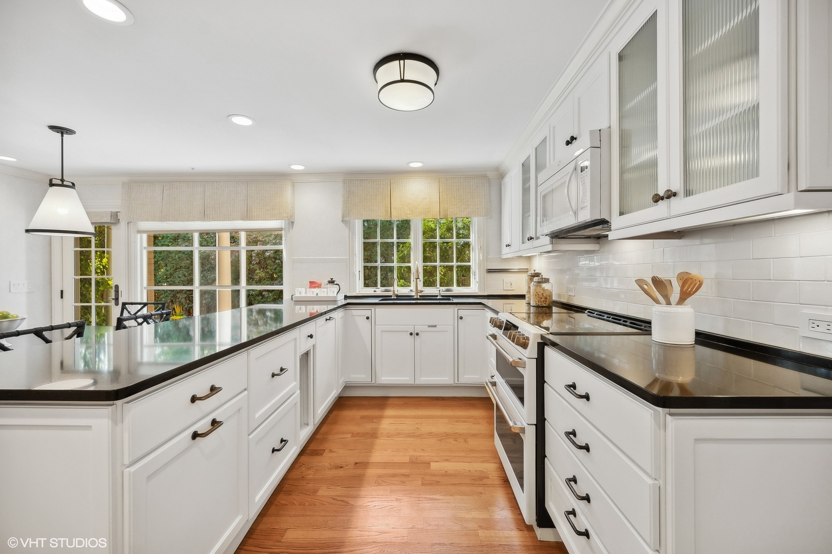 88 Abbotsford Road Winnetka, IL 60093 - Photo 18 of 46 a large white kitchen with granite countertop a sink and cabinets