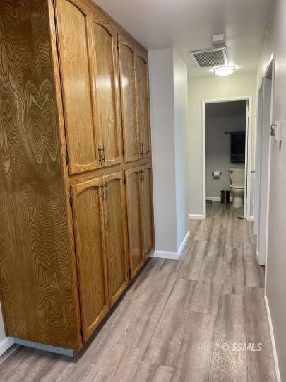 205 Chambers Street Ridgecrest, CA 93555 - Photo 23 of 32 a view of a room with wooden floor and a bathroom