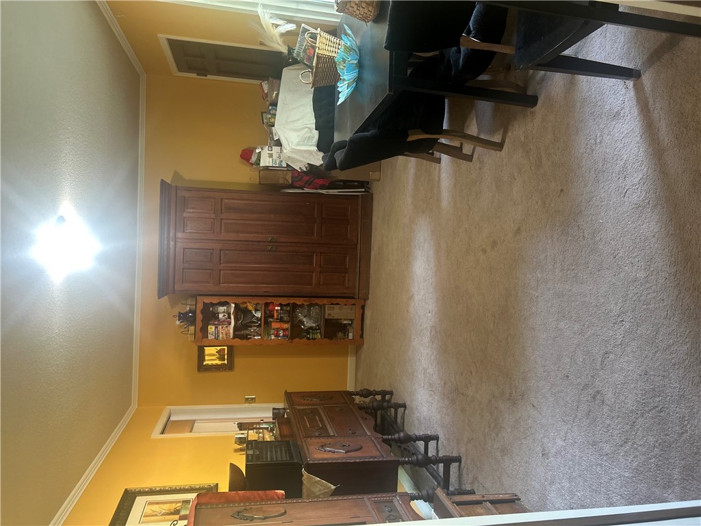 418 Saluda Road Williamston, SC 29697 - Photo 34 of 40 A well-lit interior space features soft carpet flooring and classic wood cabinetry.