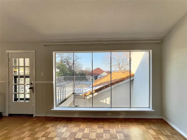 a balcony with wooden floor and lake view