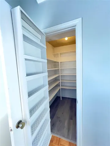 a bathroom with a granite countertop sink mirror vanity and toilet