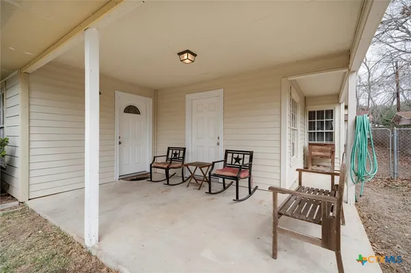 a view of two chairs in the balcony
