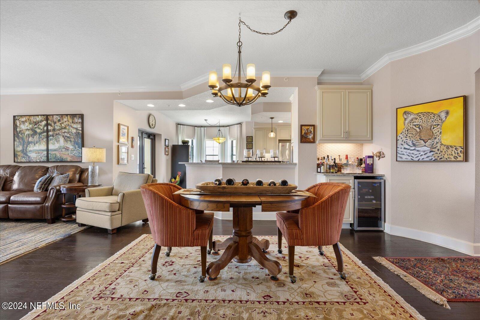3958 Baymeadows Road, Unit 4501 Jacksonville, FL 32217 - Photo 13 of 57 a view of a dining room with furniture a rug and wooden floor