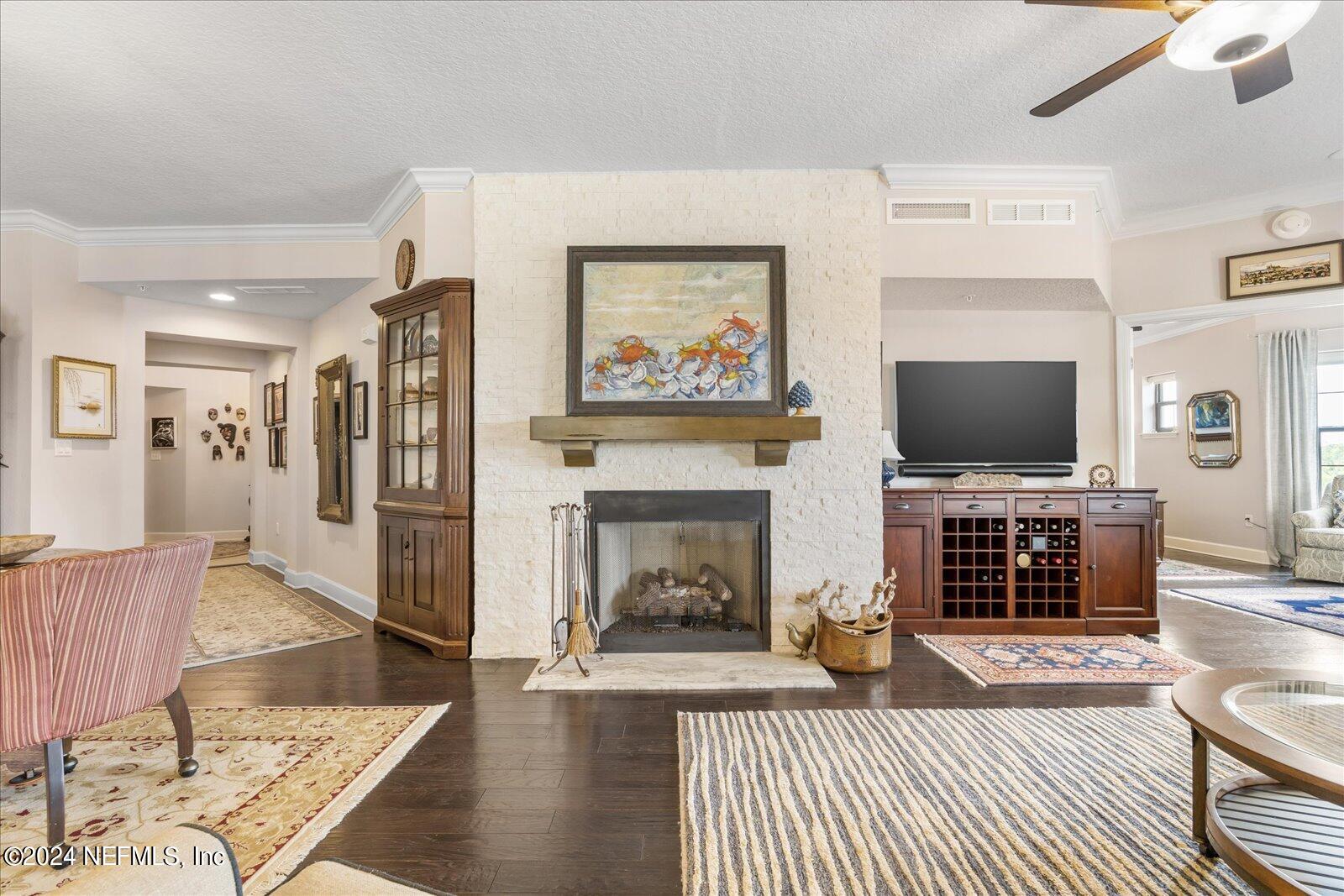 3958 Baymeadows Road, Unit 4501 Jacksonville, FL 32217 - Photo 16 of 57 a living room with furniture a flat screen tv and a fireplace