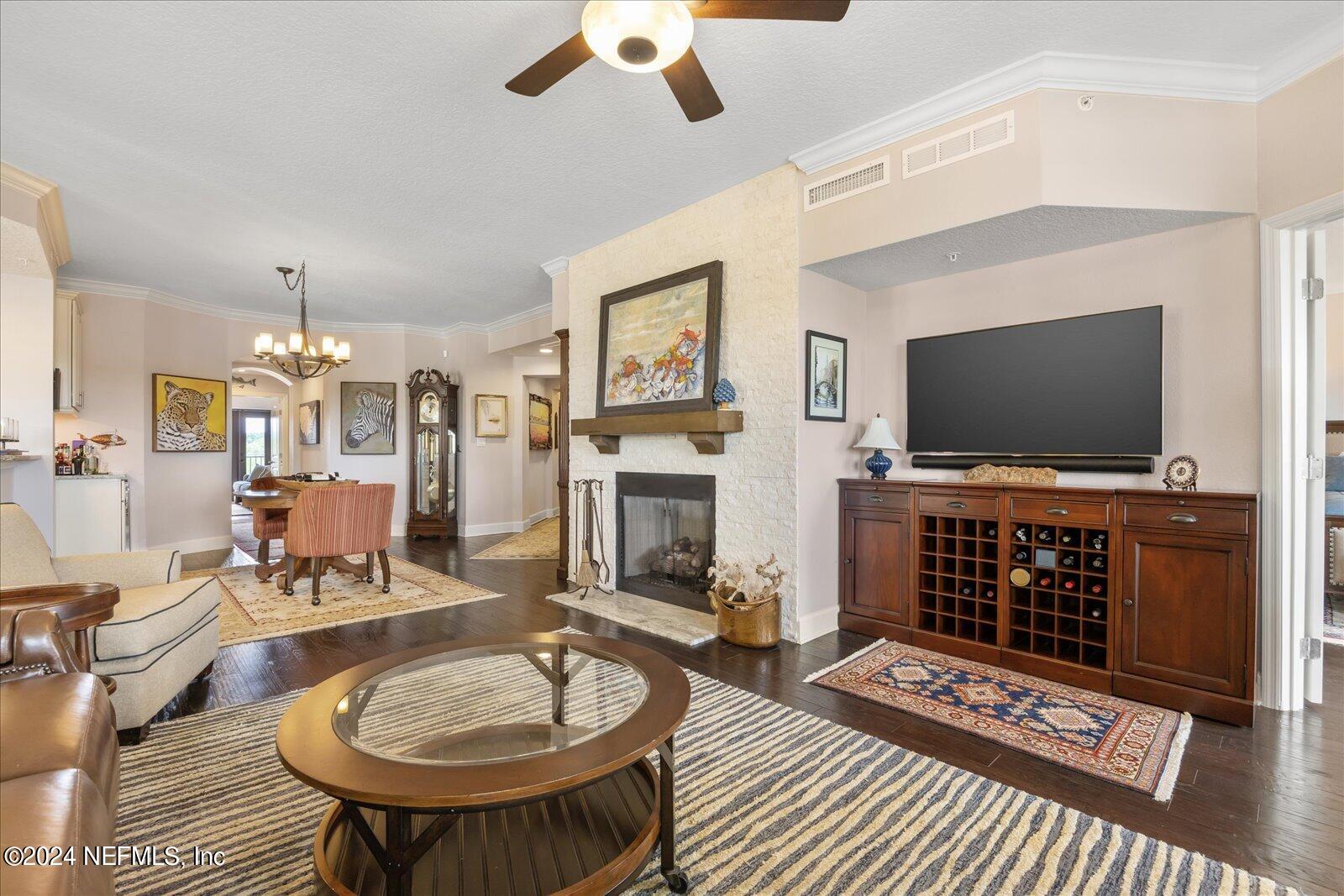 3958 Baymeadows Road, Unit 4501 Jacksonville, FL 32217 - Photo 17 of 57 a living room with furniture a flat screen tv and a fireplace