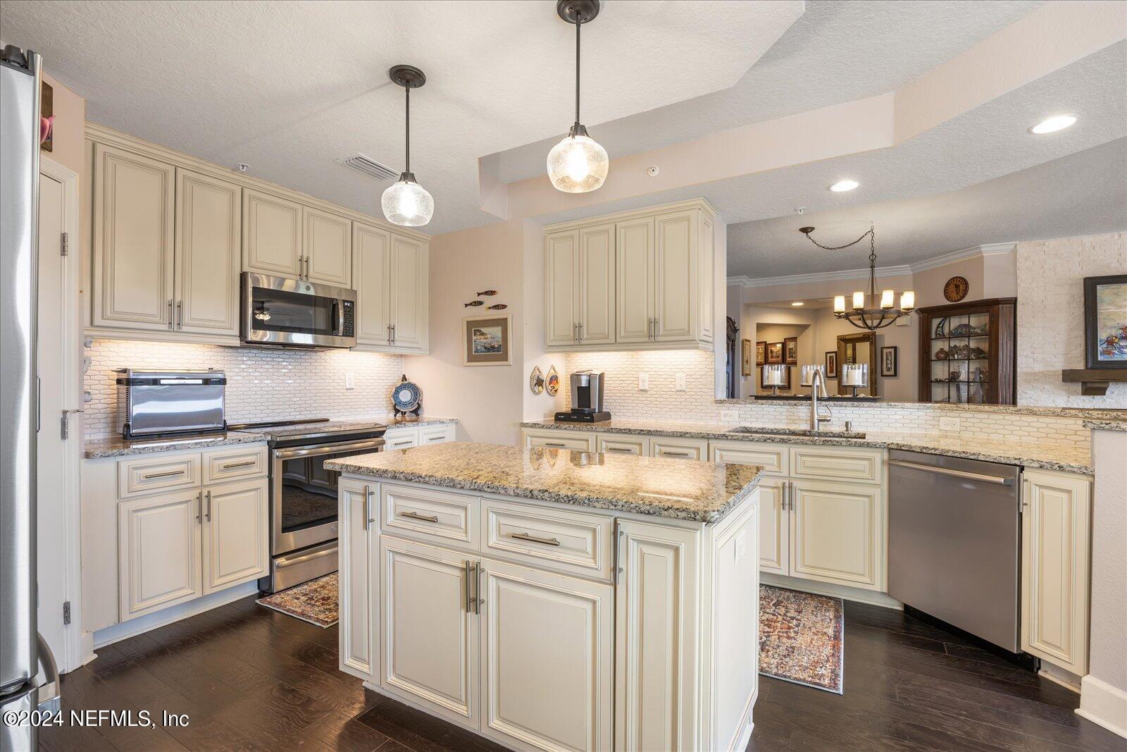 3958 Baymeadows Road, Unit 4501 Jacksonville, FL 32217 - Photo 19 of 57 a kitchen with cabinets appliances and a sink