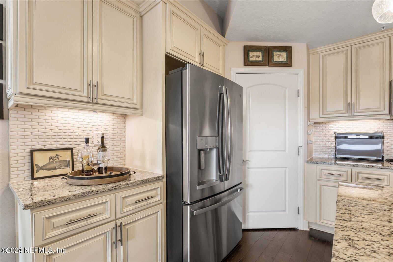 3958 Baymeadows Road, Unit 4501 Jacksonville, FL 32217 - Photo 21 of 57 a kitchen with stainless steel appliances granite countertop a refrigerator and a stove top oven