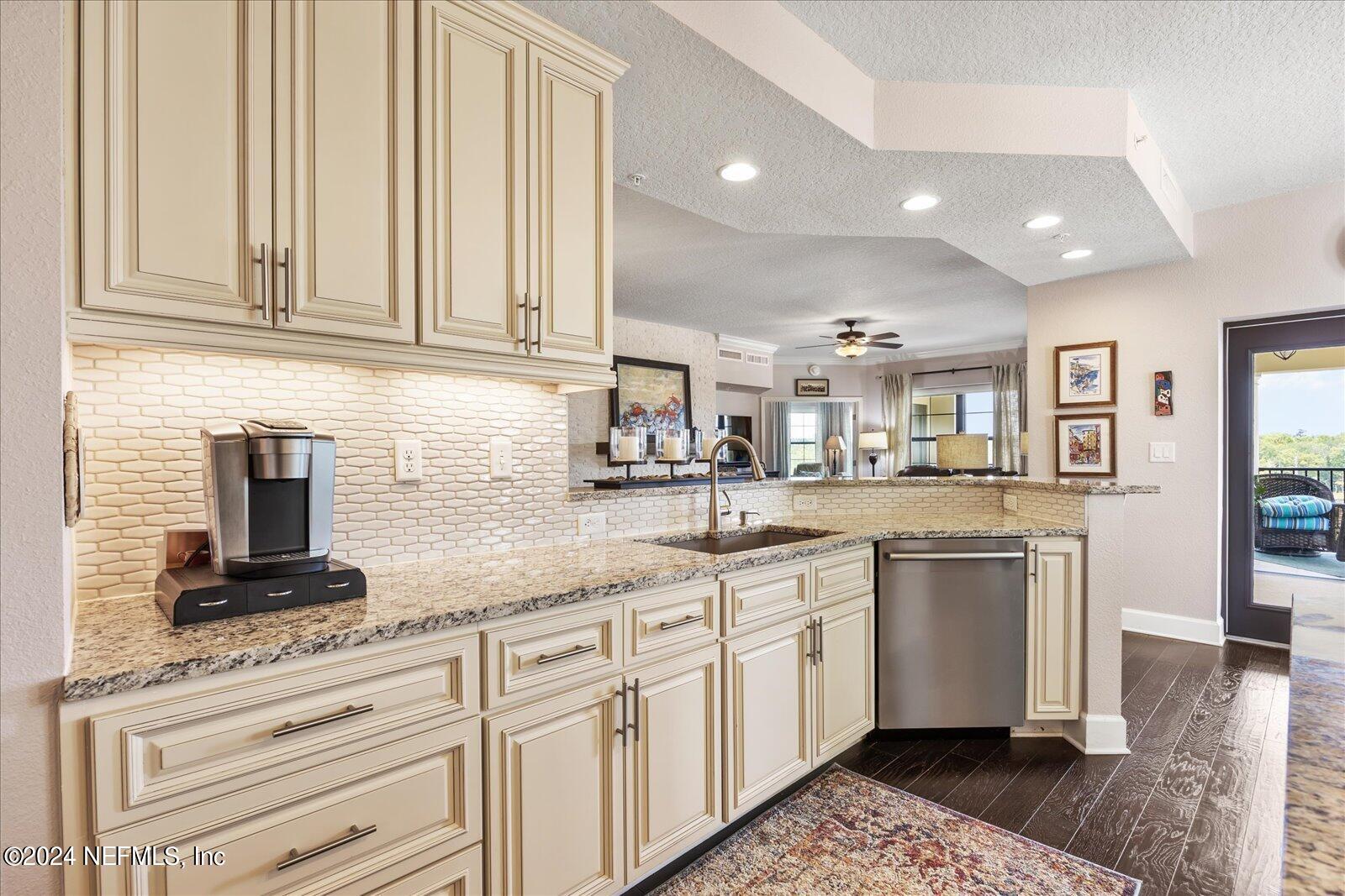 3958 Baymeadows Road, Unit 4501 Jacksonville, FL 32217 - Photo 23 of 57 a kitchen with granite countertop white cabinets and white appliances