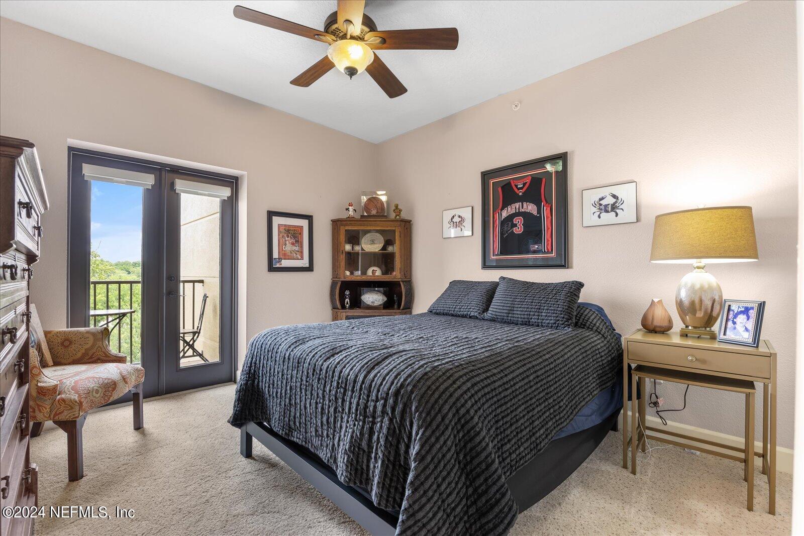 3958 Baymeadows Road, Unit 4501 Jacksonville, FL 32217 - Photo 44 of 57 a bedroom with a bed and a chandelier