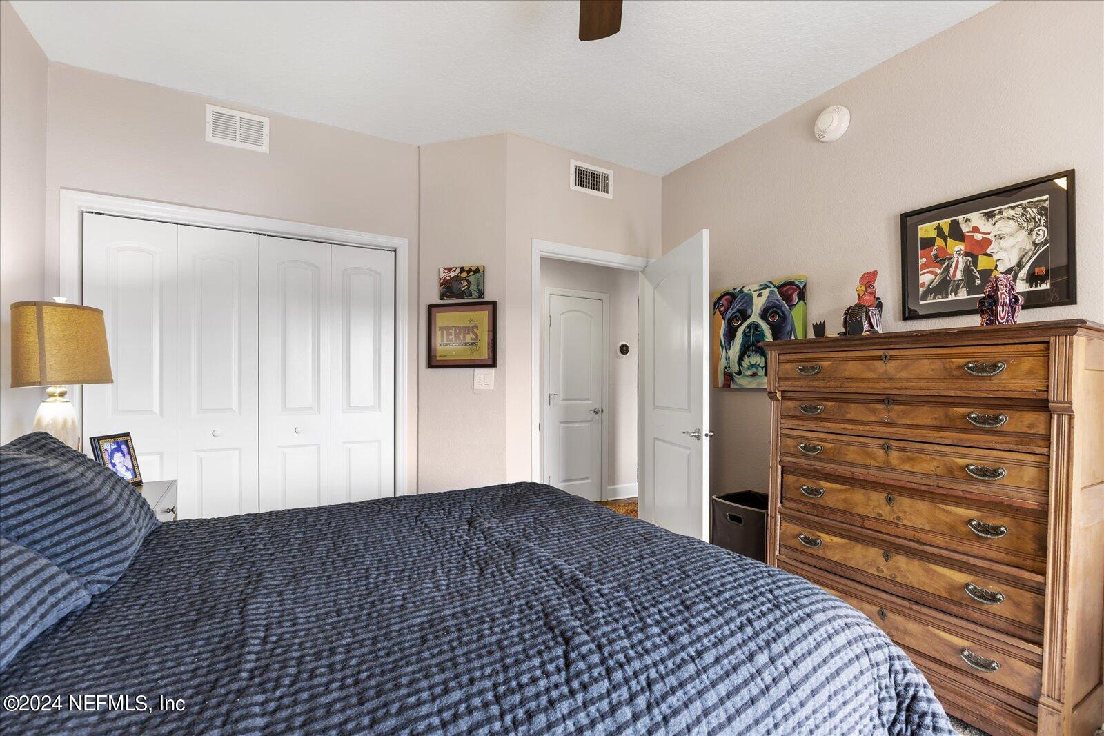 3958 Baymeadows Road, Unit 4501 Jacksonville, FL 32217 - Photo 45 of 57 a bedroom with a bed and a dresser