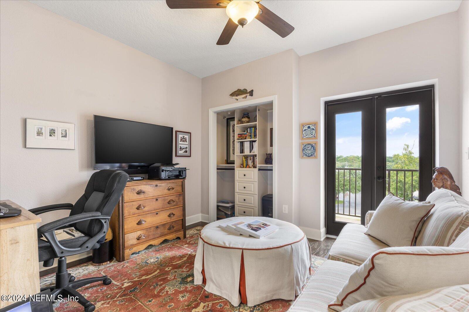 3958 Baymeadows Road, Unit 4501 Jacksonville, FL 32217 - Photo 49 of 57 a living room with furniture and a flat screen tv