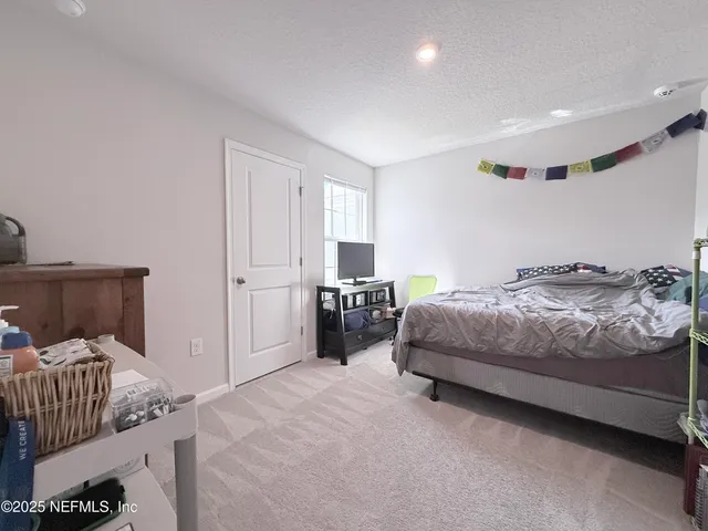 a bedroom with a bed and a lamp