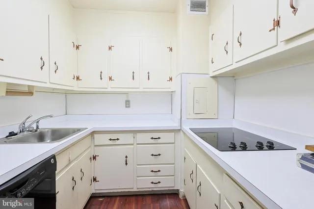 a kitchen with cabinets and white appliances
