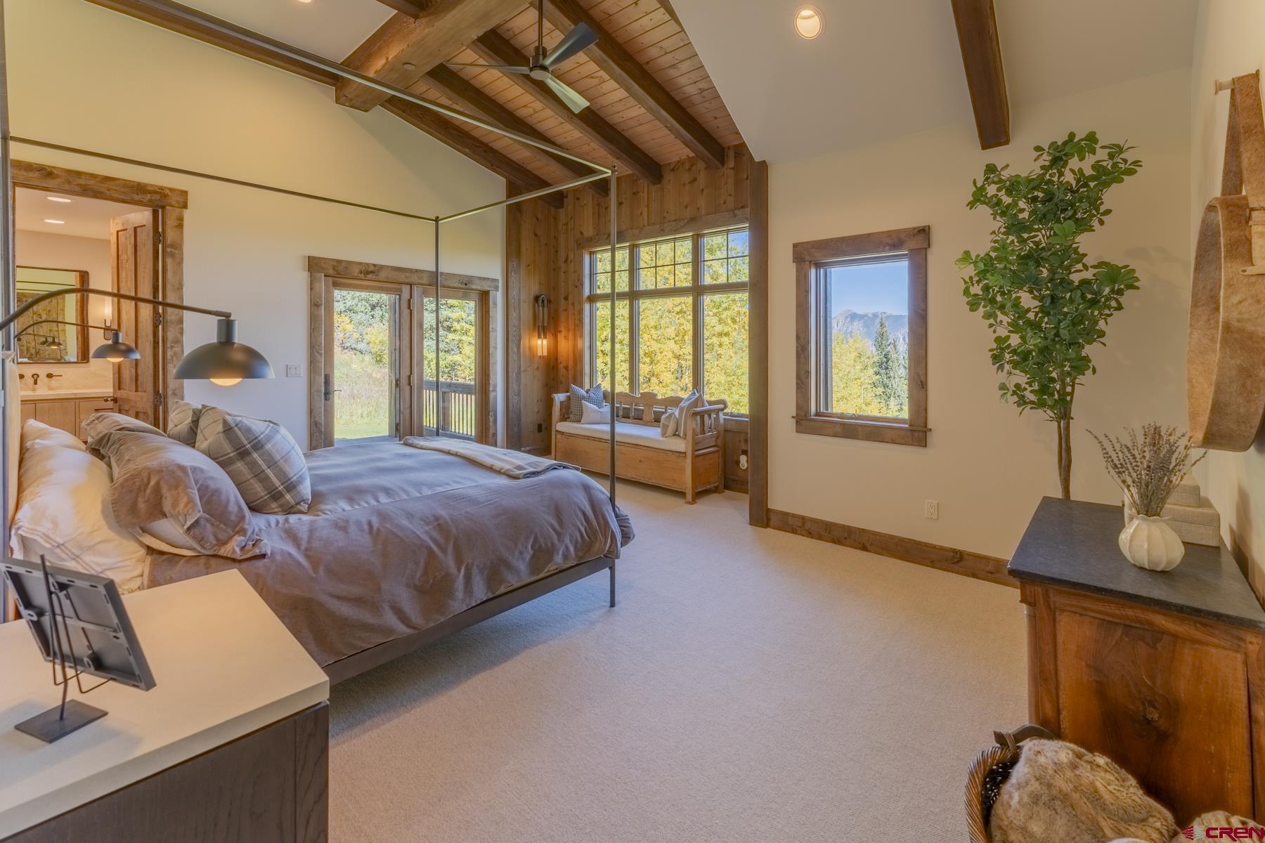 1610 Red Mountain Ranch Road Crested Butte, CO 81224 - Photo 19 of 35 a spacious bedroom with a bed and wooden floor