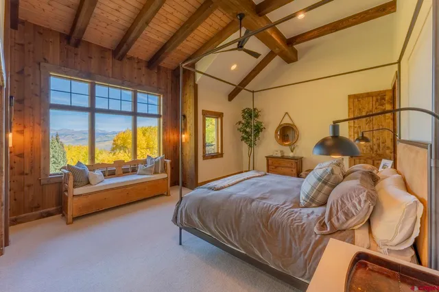 a living room with furniture and large windows