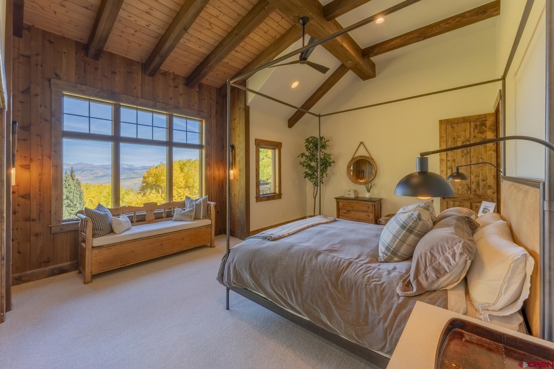 1610 Red Mountain Ranch Road Crested Butte, CO 81224 - Photo 20 of 35 a bedroom with a bed and a chandelier