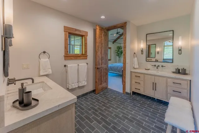 a room with wooden floor pool table and a window