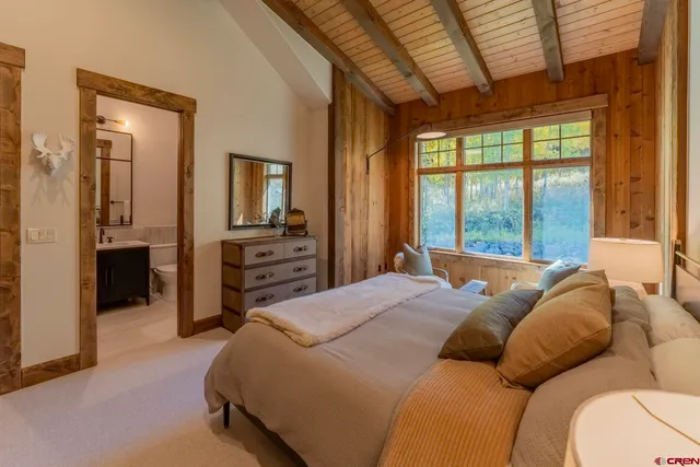 a spacious bedroom with a bed and a couch