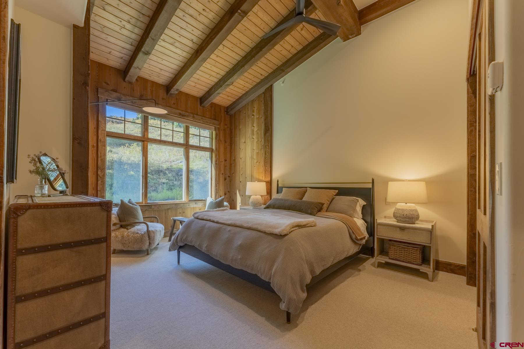 1610 Red Mountain Ranch Road Crested Butte, CO 81224 - Photo 26 of 35 a spacious bedroom with a bed and a couch