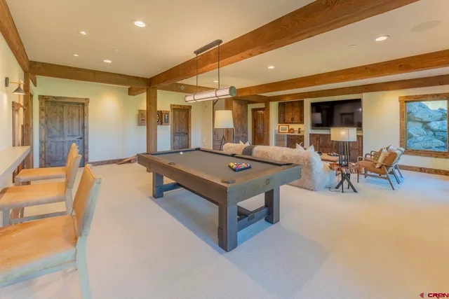 a dining room with furniture and wooden floor