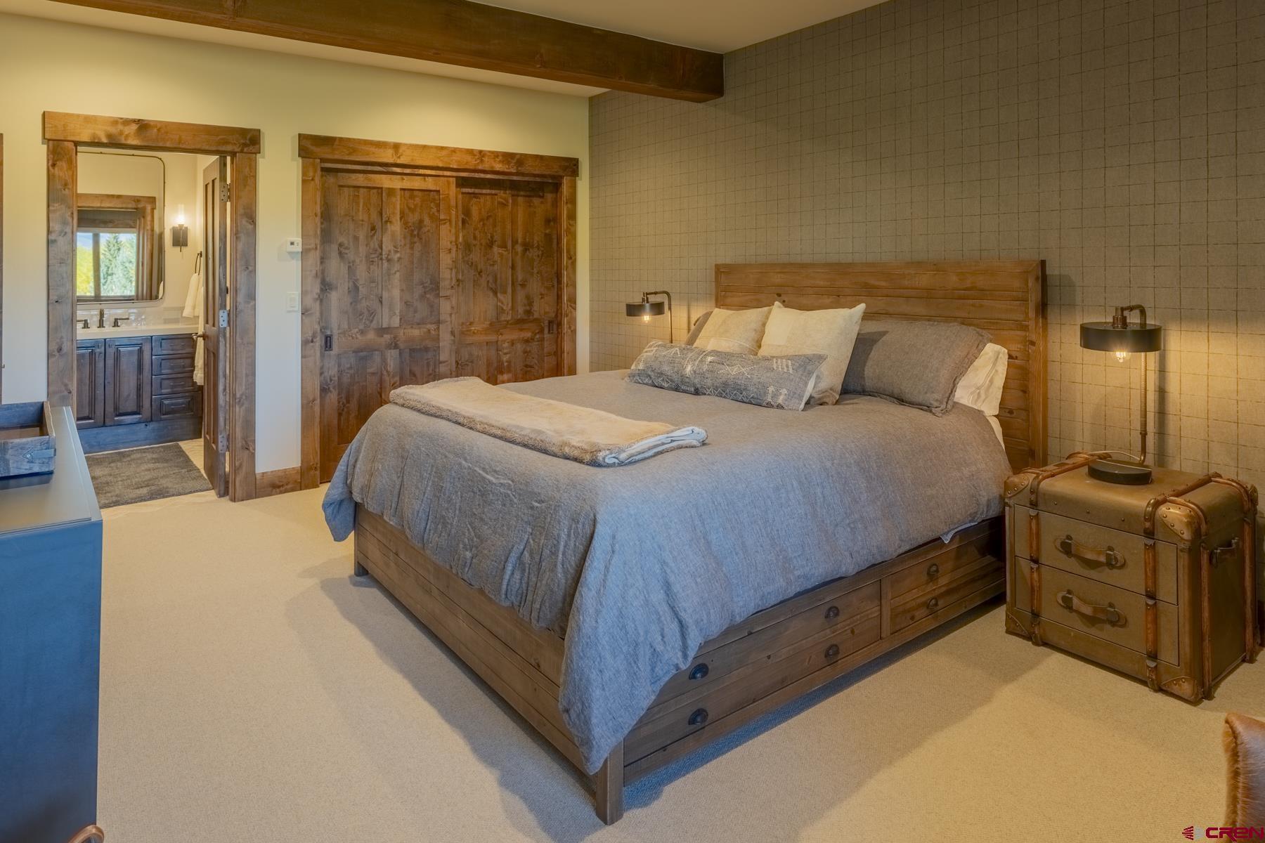 1610 Red Mountain Ranch Road Crested Butte, CO 81224 - Photo 33 of 35 a bedroom with a bed and a mirror