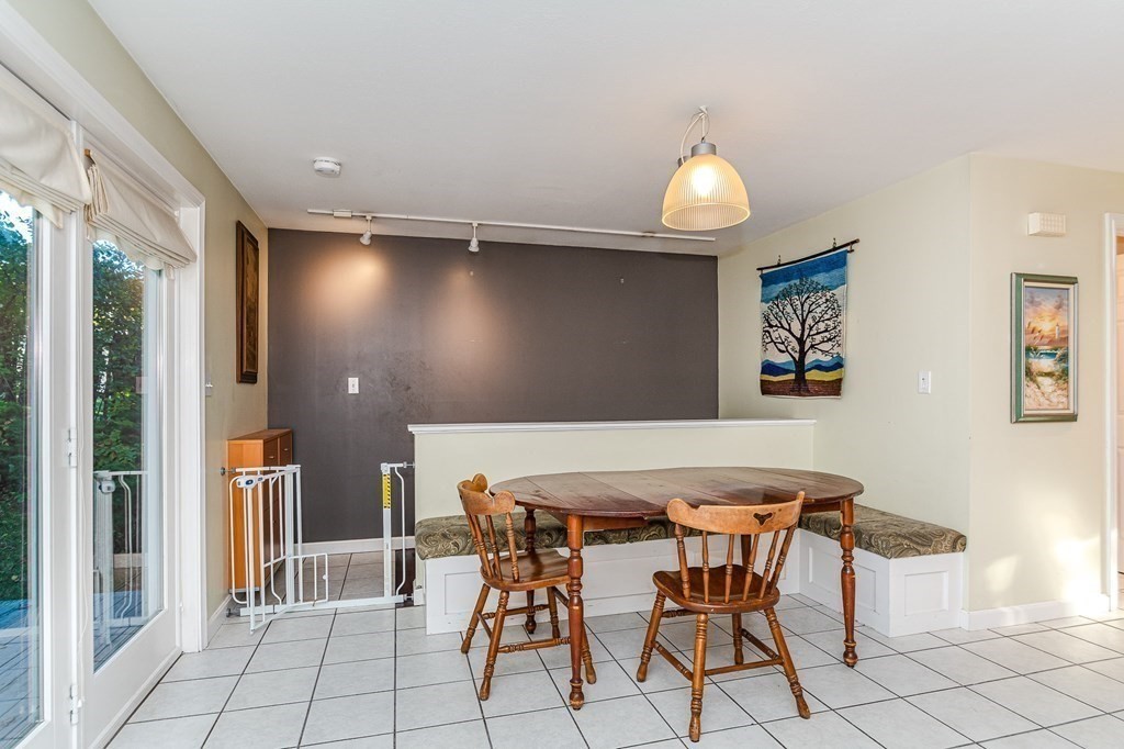 193 Acropolis Road Lowell, MA 01854 - Photo 16 of 39 a view of a dining room with furniture and chandelier