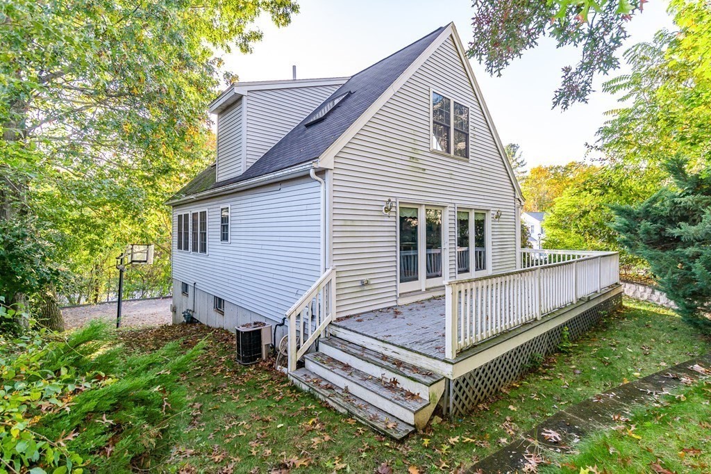 193 Acropolis Road Lowell, MA 01854 - Photo 31 of 39 a view of a house with a yard and wooden fence