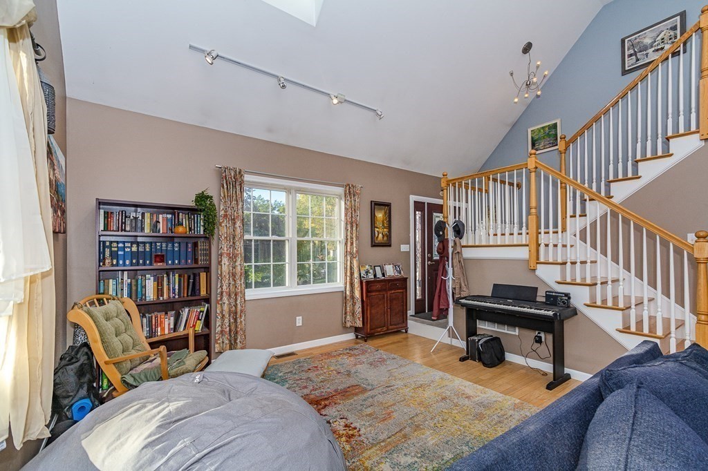 193 Acropolis Road Lowell, MA 01854 - Photo 8 of 39 a bedroom with furniture and a book shelf