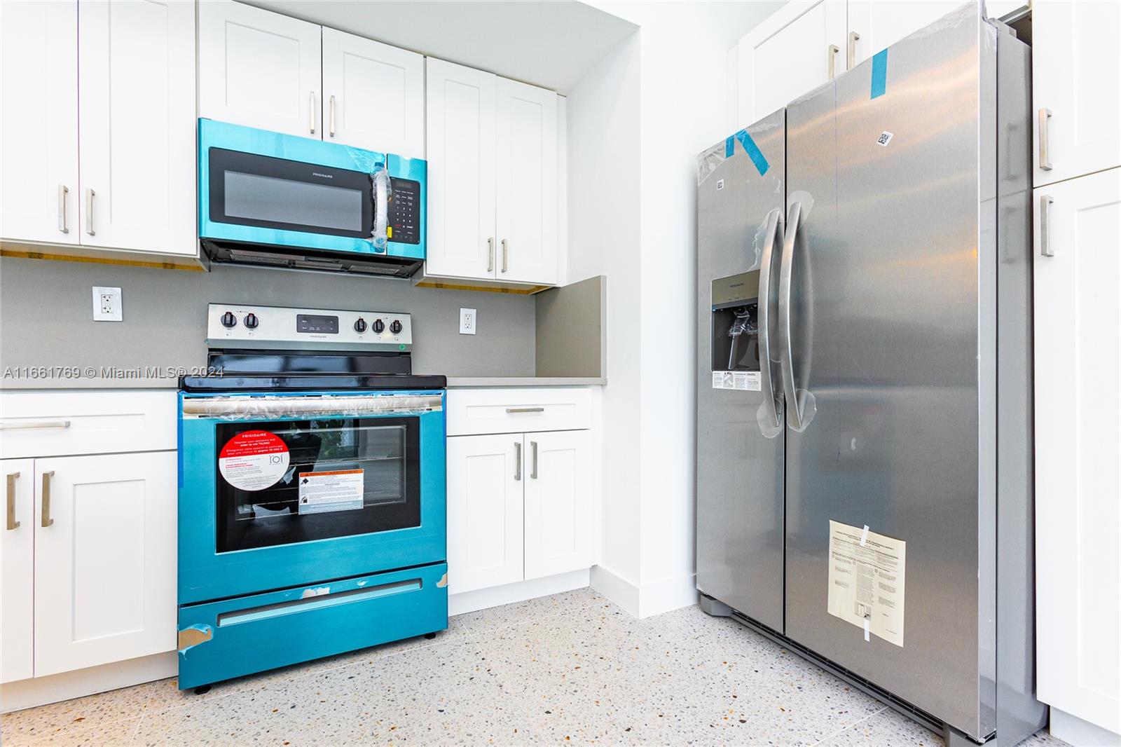 170 Southwest 38th Court Miami, FL 33134 - Photo 29 of 37 a kitchen with stainless steel appliances granite countertop a refrigerator and a stove
