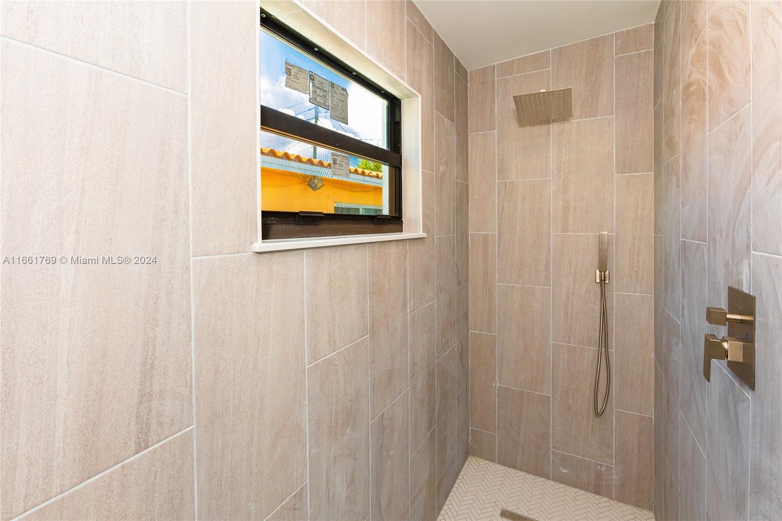 170 Southwest 38th Court Miami, FL 33134 - Photo 32 of 37 a bathroom with a window and a shower