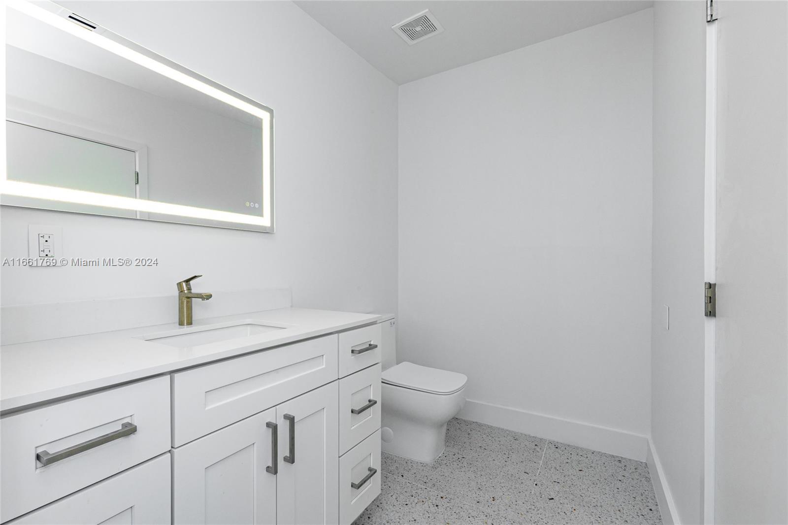 170 Southwest 38th Court Miami, FL 33134 - Photo 33 of 37 a bathroom with a granite countertop toilet and sink