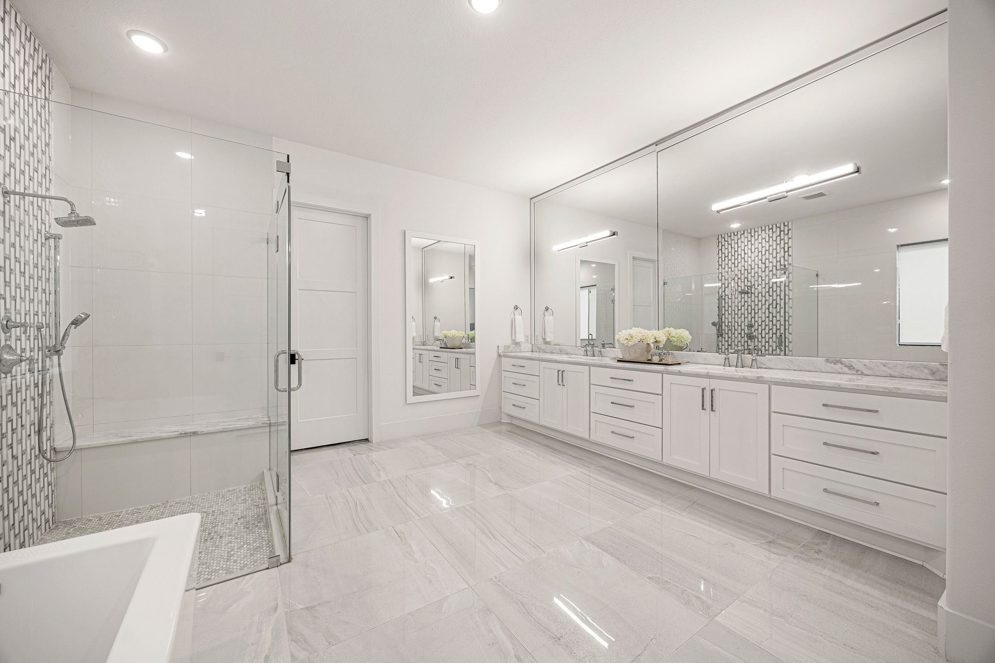 27903 Indigo Ridge Drive Fulshear, TX 77441 - Photo 19 of 50 Spa-inspired primary bathroom with dual vanities, a walk-in shower, soaking tub, and luxury finishes throughout.