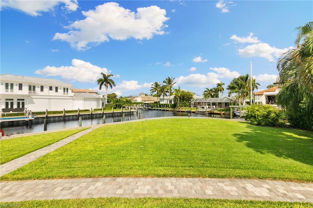 2140 Shad Court Naples, FL 34102 - Photo 20 of 44 a view of a swimming pool with an outdoor space and seating area