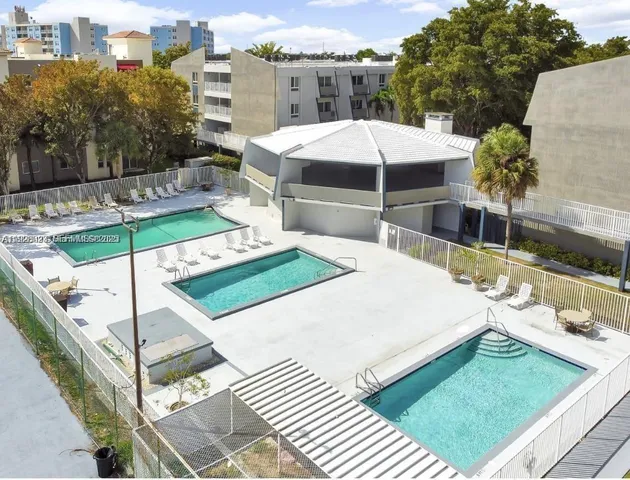 a swimming pool with outdoor seating and yard