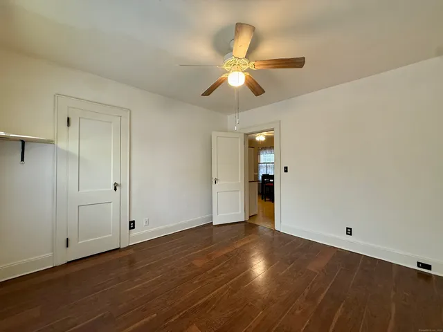 a view of an empty room and wooden floor