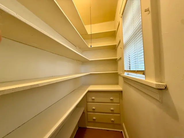 a view of walk in closet with empty racks
