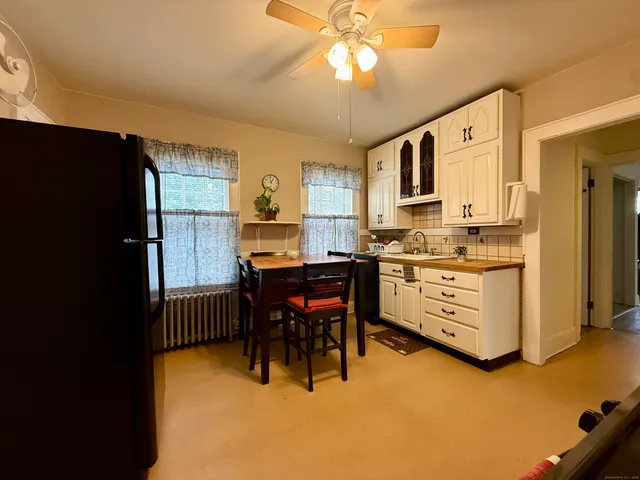 a view of kitchen with microwave and cabinets