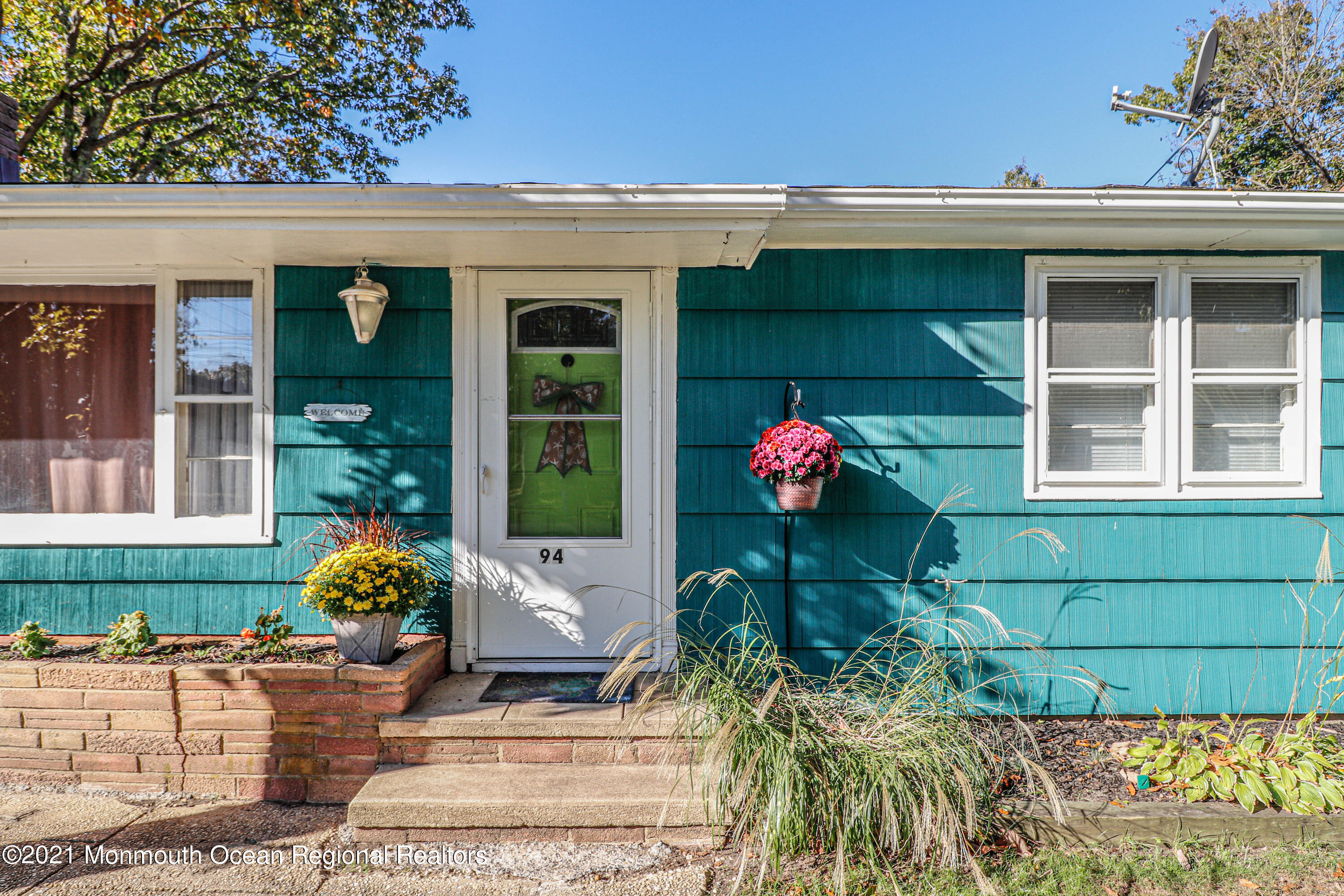 94 London Road Brick, NJ 08723 - Photo 4 of 43 a house with beautiful flower garden in front of it