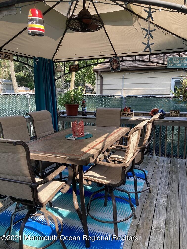 94 London Road Brick, NJ 08723 - Photo 38 of 43 a view of a patio with table and chairs with wooden floor