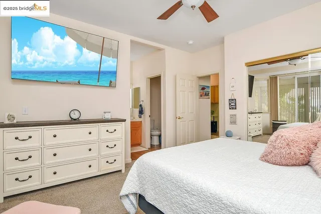 a bed sitting in a bedroom next to a window