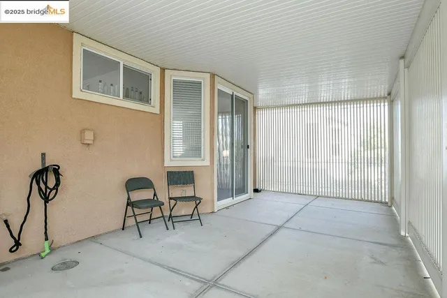 a view of balcony with two chairs and a potted plant