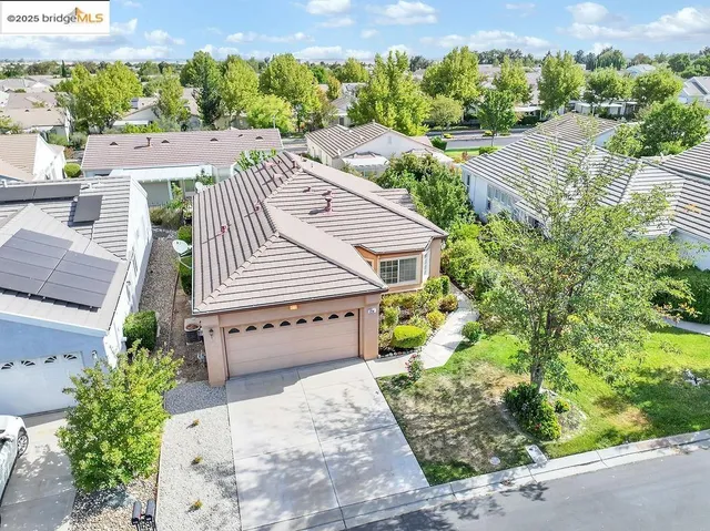 aerial view of a house with a yard and potted plants