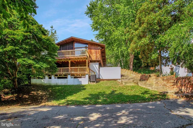 a front view of a house with yard and green space